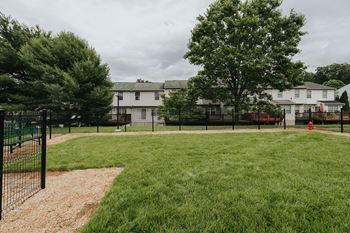 A baseball field with a fence and a sign in the background.